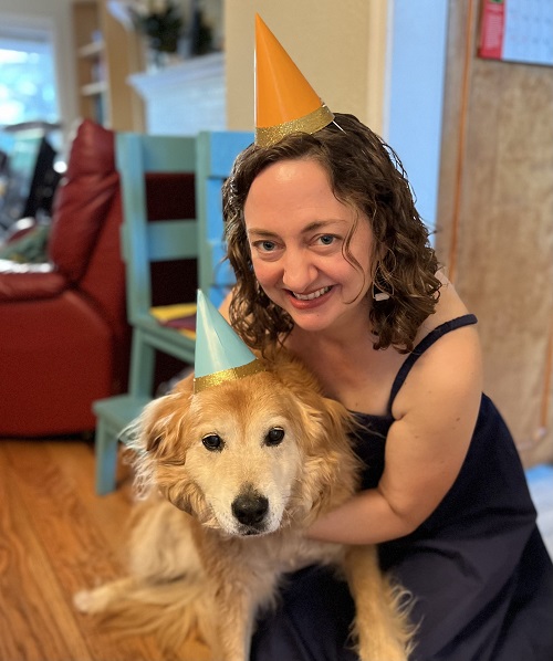 Maddy Walton-Hadlock holding golden retriever dog