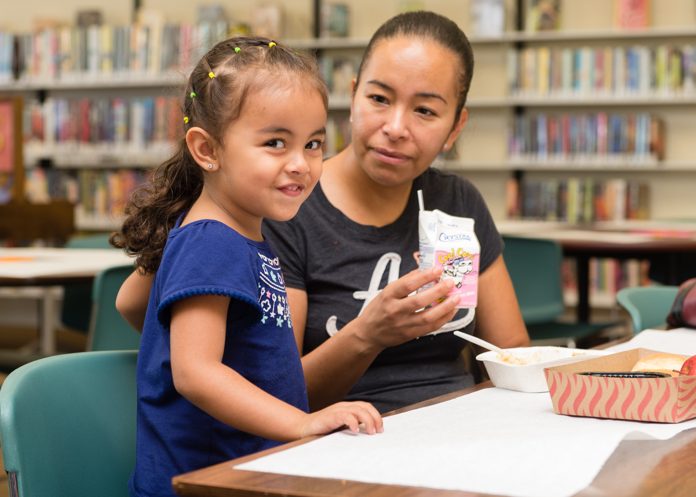 Mother and daughter eat lunch at the library