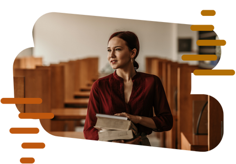 Woman in red blouse holding a stack of books.